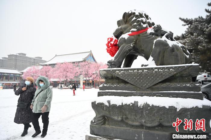 2月13日，民眾在呼和浩特市大召廣場雪中漫步?！⑽娜A 攝