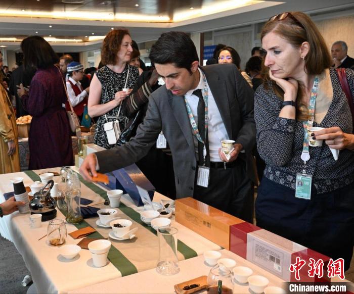 現(xiàn)場觀眾觀看中國展臺茶藝表演、了解茶文化。　靖樹 攝