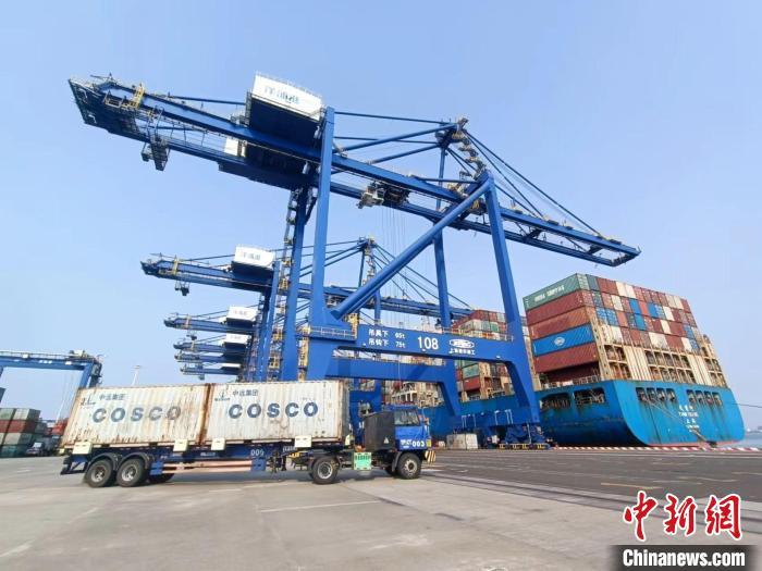 圖為海南洋浦國(guó)際集裝箱碼頭，卡車將集裝箱從后方堆場(chǎng)運(yùn)往碼頭裝卸區(qū)?！?jiān)潞?攝