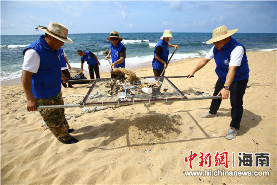 環(huán)保志愿者用篩網(wǎng)“淘”出海灘上的垃圾。