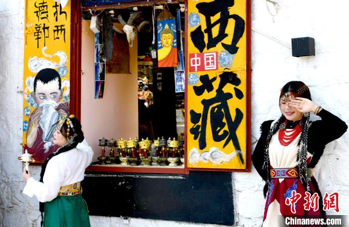 4月17日，游客身著藏式元素服裝在拉薩八廓街拍照留念?！±盍?攝