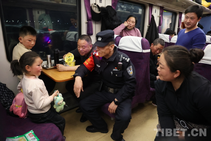 乘警長左紅彬在巡視車廂間隙，向攜帶兒童的旅客專門叮囑安全注意事項。.JPG